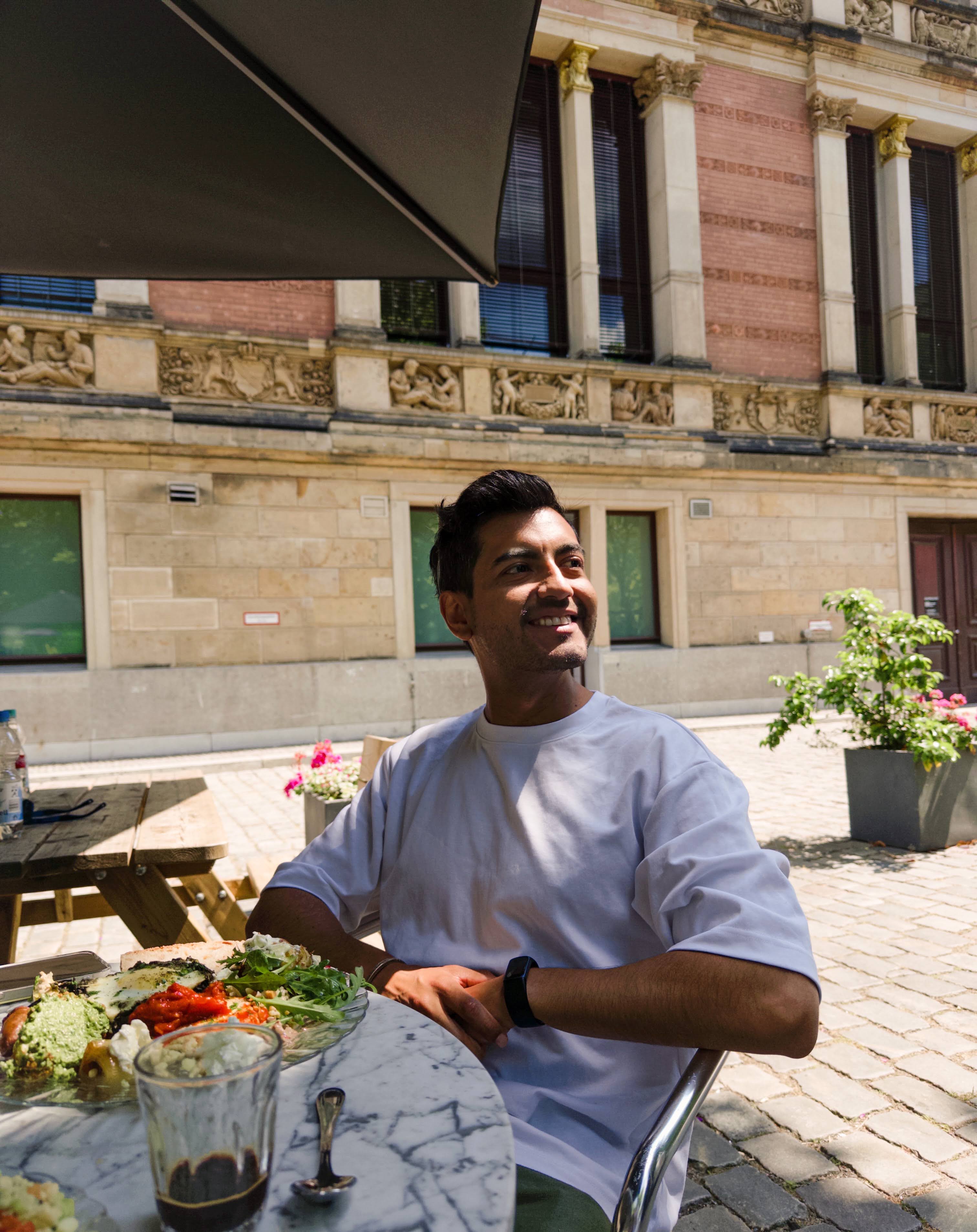 Hugo smiling at an outdoor café